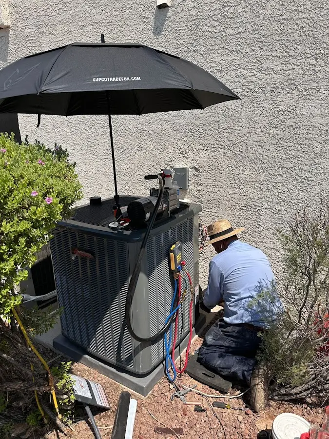 HVAC technician performing outdoor AC maintenance in Havre